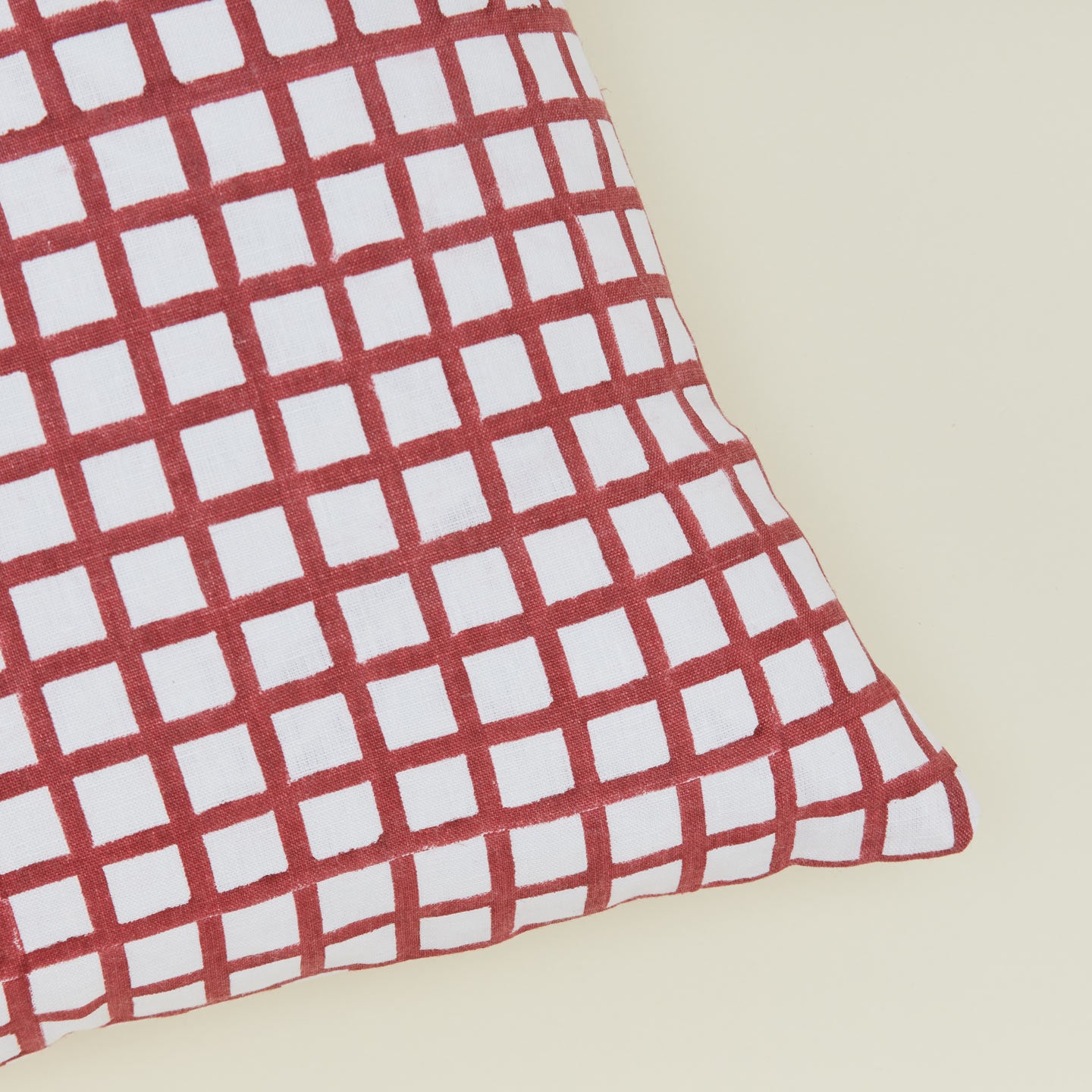 Detail of block printed grid pillow in Red.