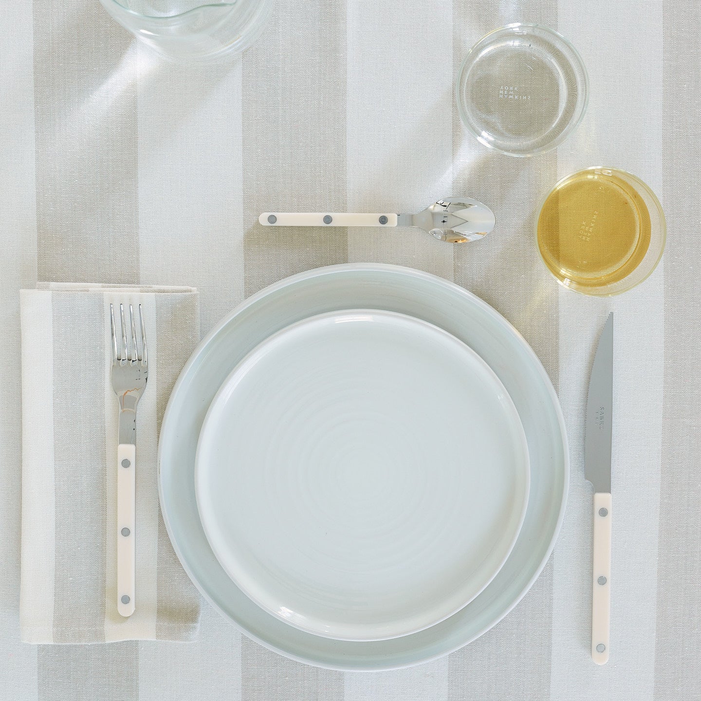 Placesetting on Essential Striped Tablecloth in Ivory and Flax.