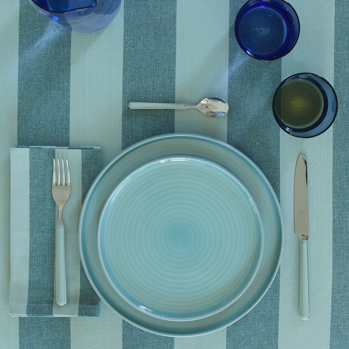 Placesetting on Essential Striped Tablecloth in Sky and Peacock.