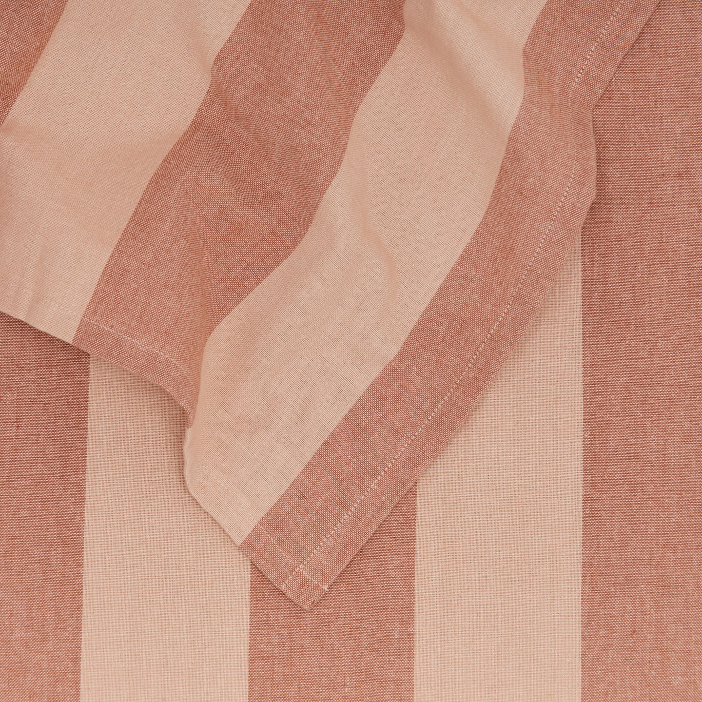 Close up of Essential Striped Tablecloth in Blush and Terracotta.