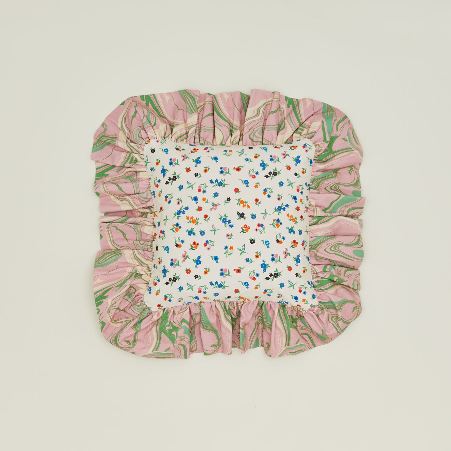 A ruffled floral cushion with a peony pattern.