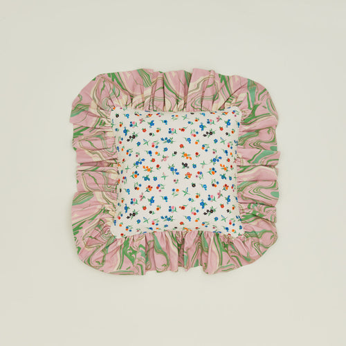 A ruffled floral cushion with a peony pattern.