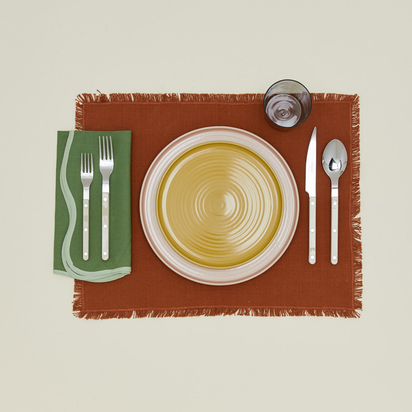 Modafleur scalloped napkin in grass with place setting on placemat
