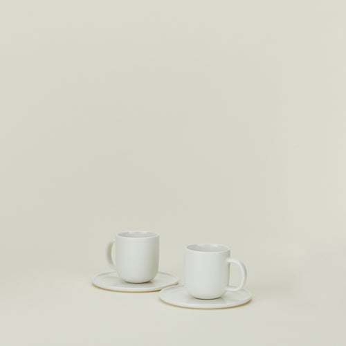 Simple porcelain espresso mugs with saucers in white