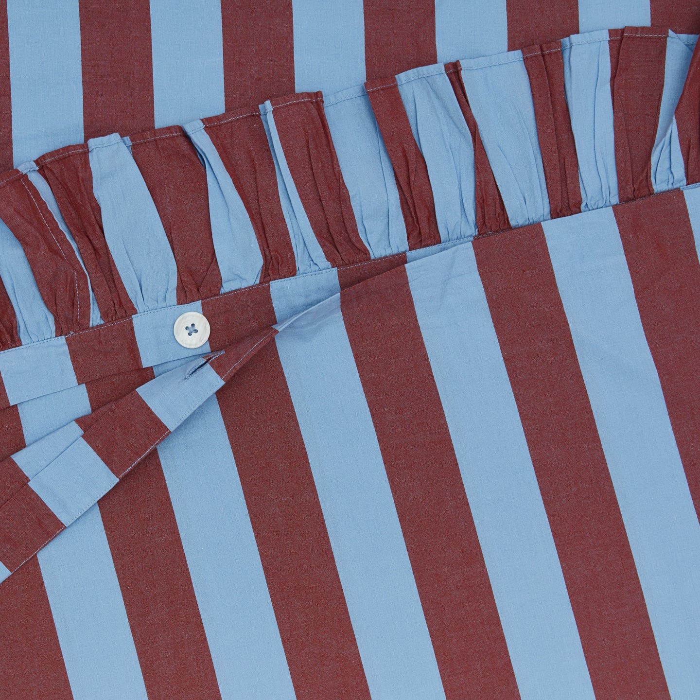 Detailed view of blue and red striped duvet cover
