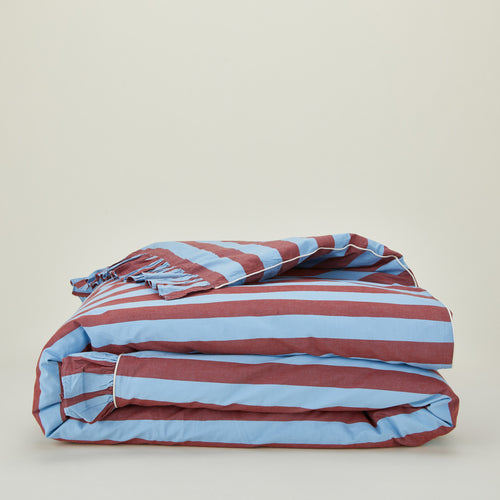 Folded blue and red striped ruffled duvet cover