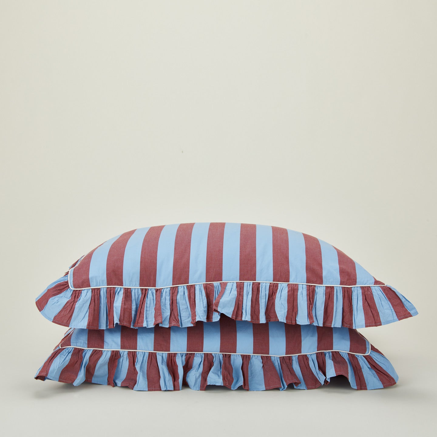 2 Stacked ruffled pillowcases in blue and red