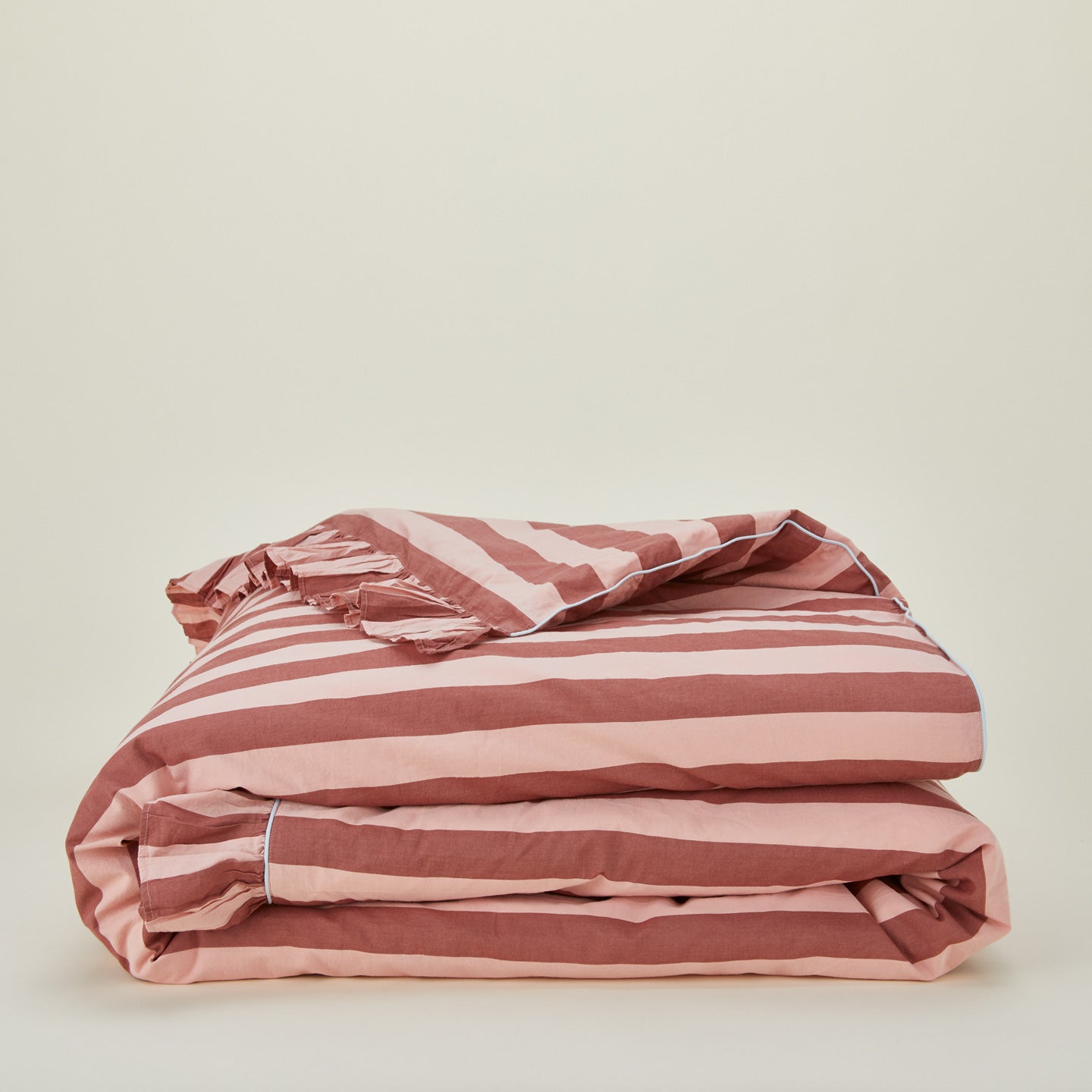 Folded blush and terracotta striped ruffled duvet cover